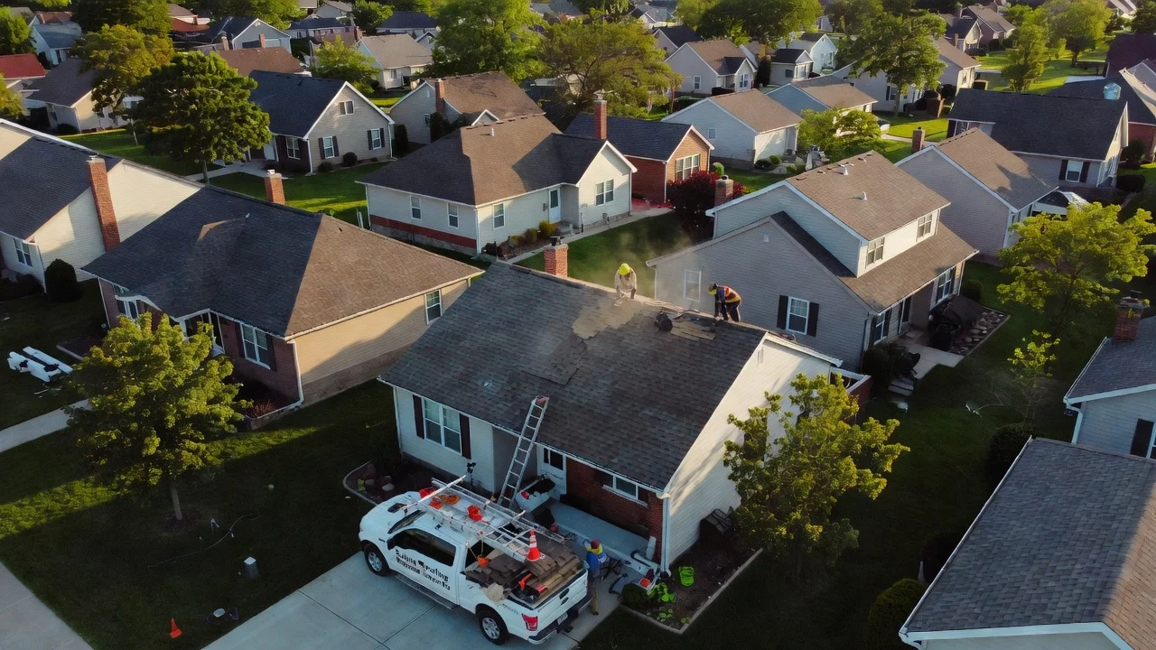 iQ Marketers aerial view of Saline Michigan rooftops with roofing truck parked in driveway.